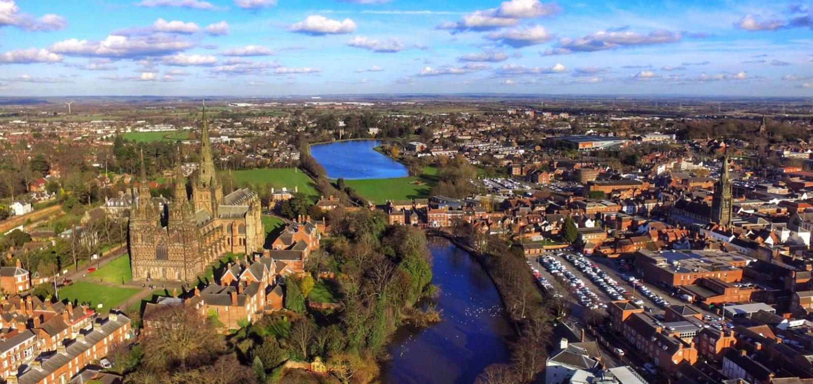 Lichfield cathedral stands beside the river Trent in a cityscape