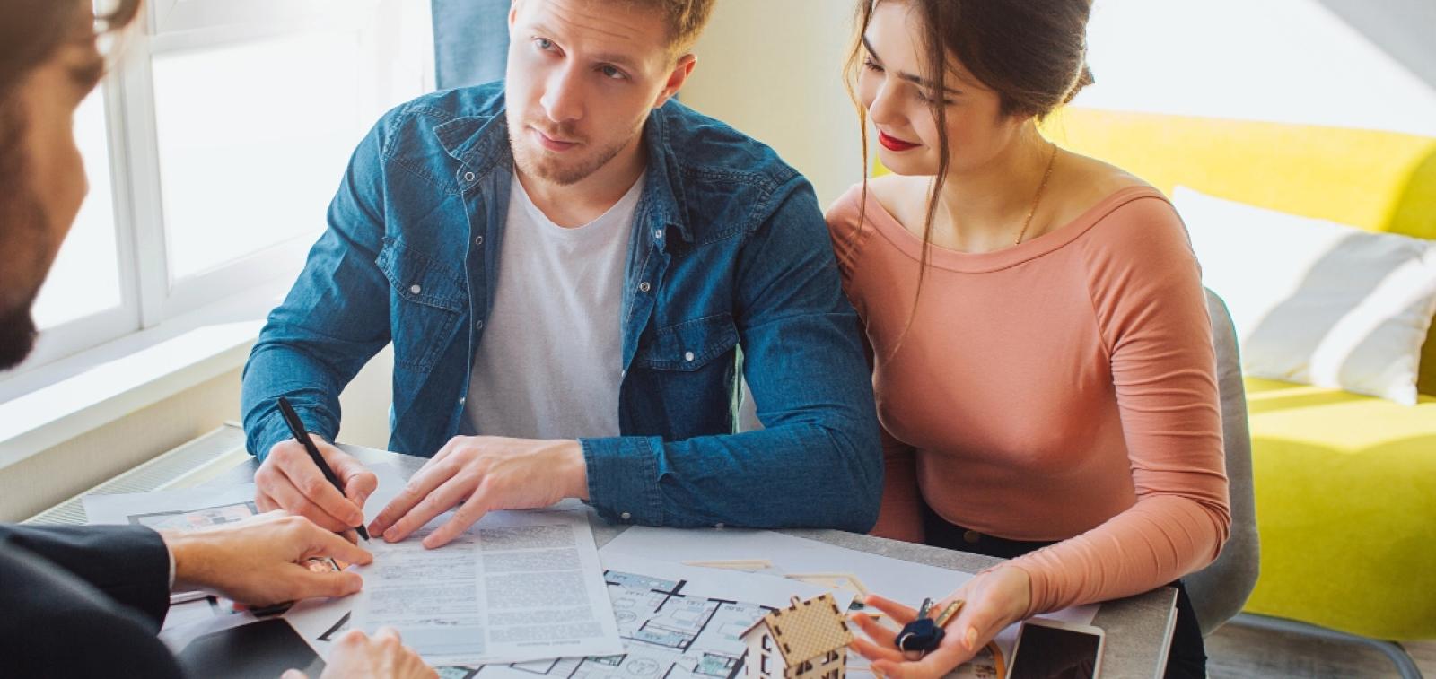  Couple signing forms for a new home