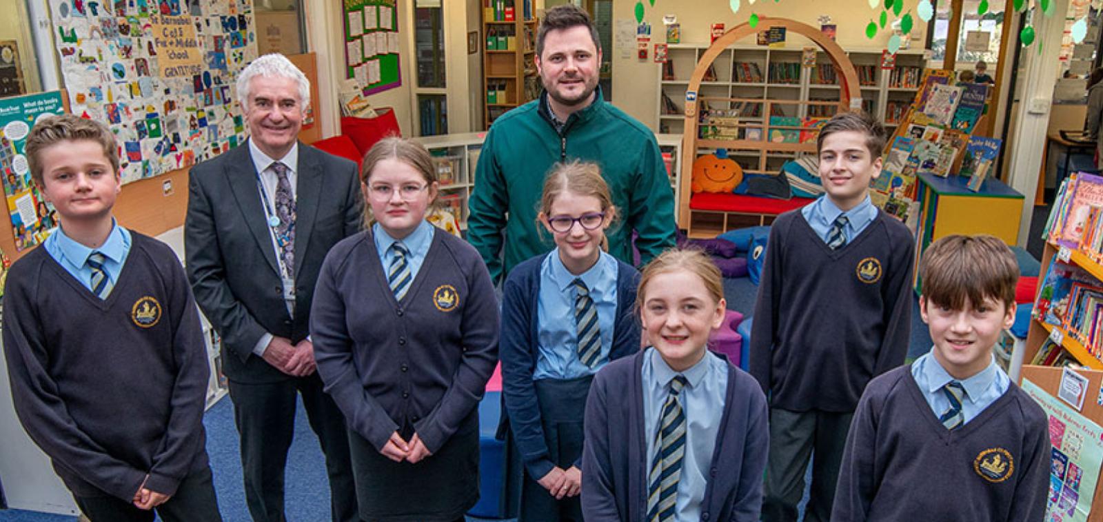 Children, construction manager and head teacher in the new library at St Barnabas school