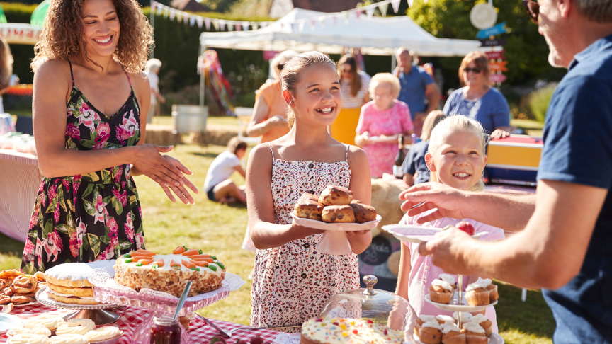 Image of people of all ages enjoying a summer fete on a summers day