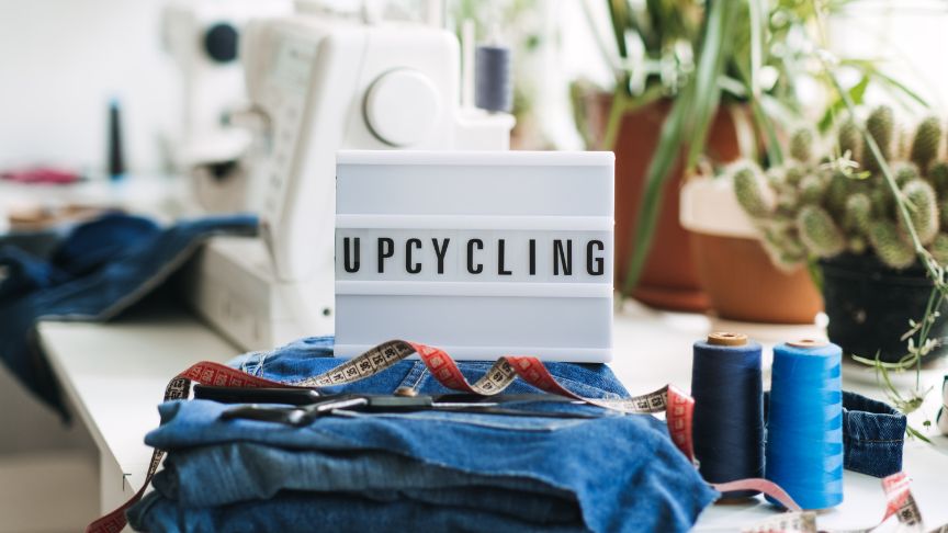 A lightbox placed on a desk spelling out upcycling.