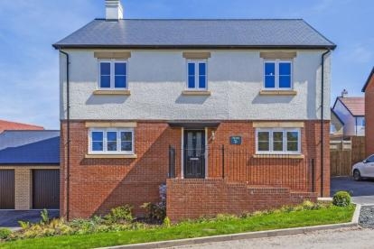 Modern two-story detached home with red brick and white stucco exterior, garage, landscaped front garden, and a stylish black front door.