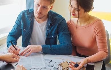  Couple signing forms for a new home