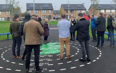 A group of local people listening to a speaker at the Newfield Square development