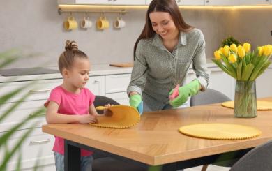 A mother and daughter cleaning their kitchen