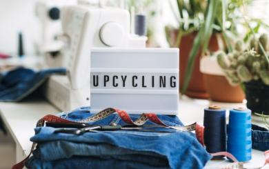 A lightbox placed on a desk spelling out upcycling.