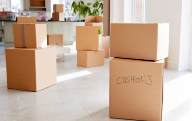 A pile of moving boxes spread across the floor
