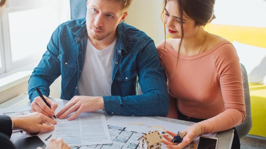  Couple signing forms for a new home