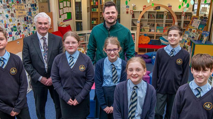 Children, construction manager and head teacher in the new library at St Barnabas school